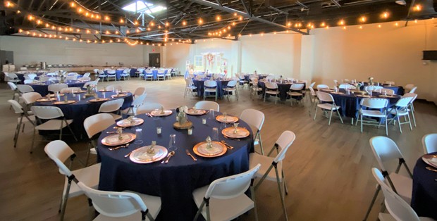 tables with luxurious place settings in event space