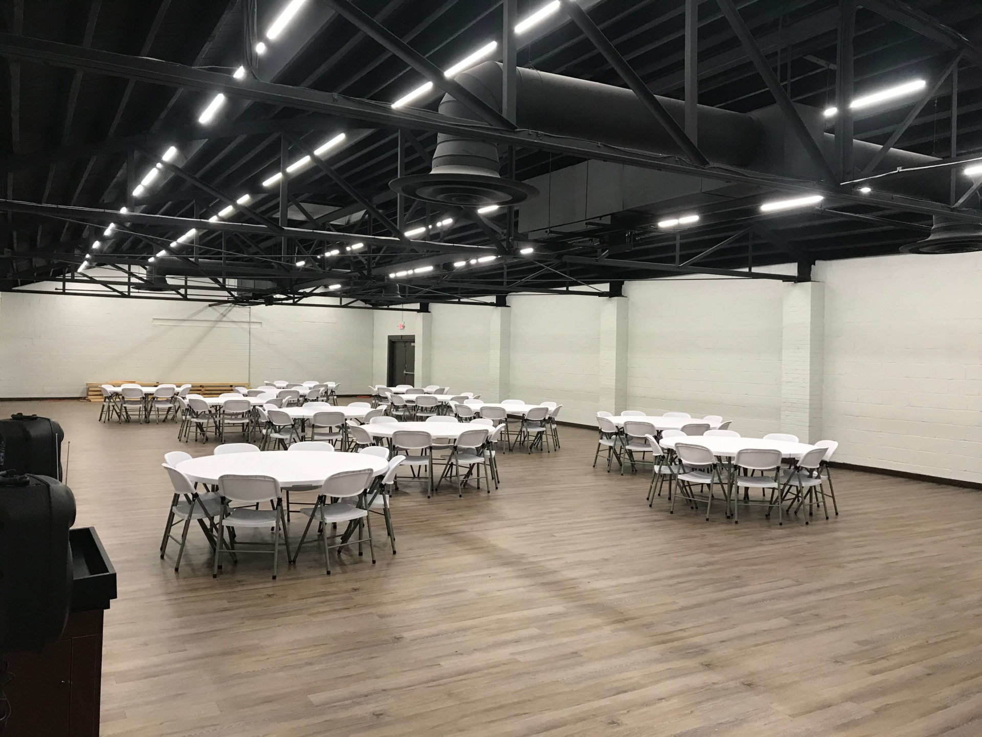 large meeting space with 12 rounds of 8 tables setup